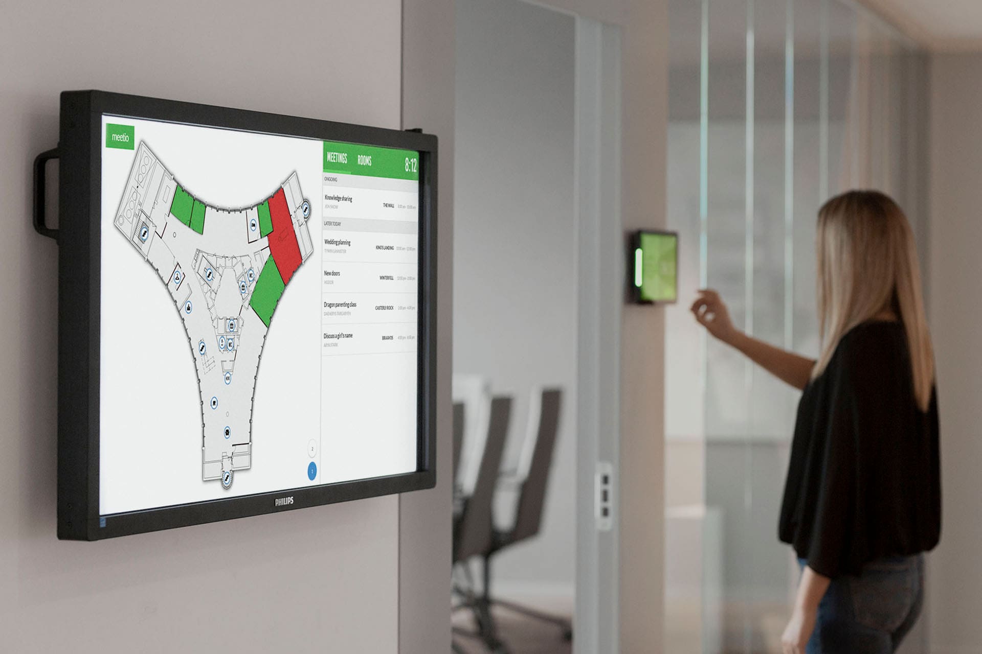 Woman booking a meeting room on a room display